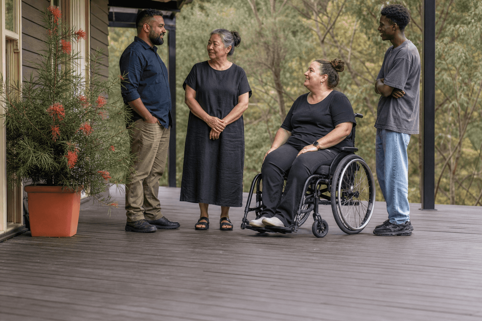 Illustration of four adults talking on a suburban veranda, one using a wheelchair. Not a Villa participant, employee, or named person.