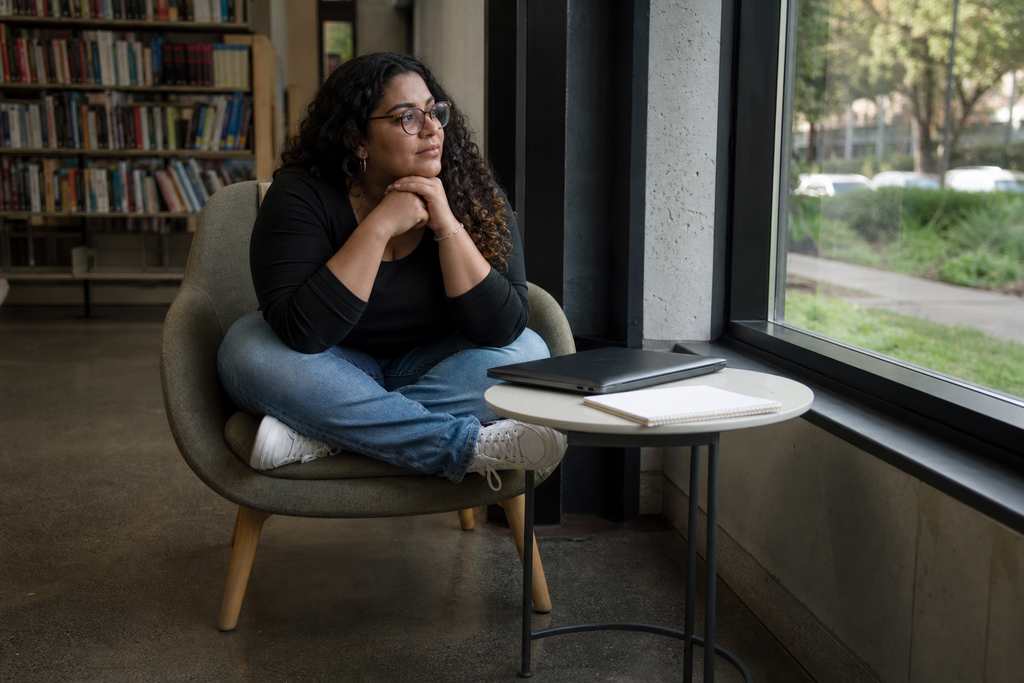 Illustration of a person planning in a library nook with a laptop and notebook. Not a Villa participant, employee, or named person.