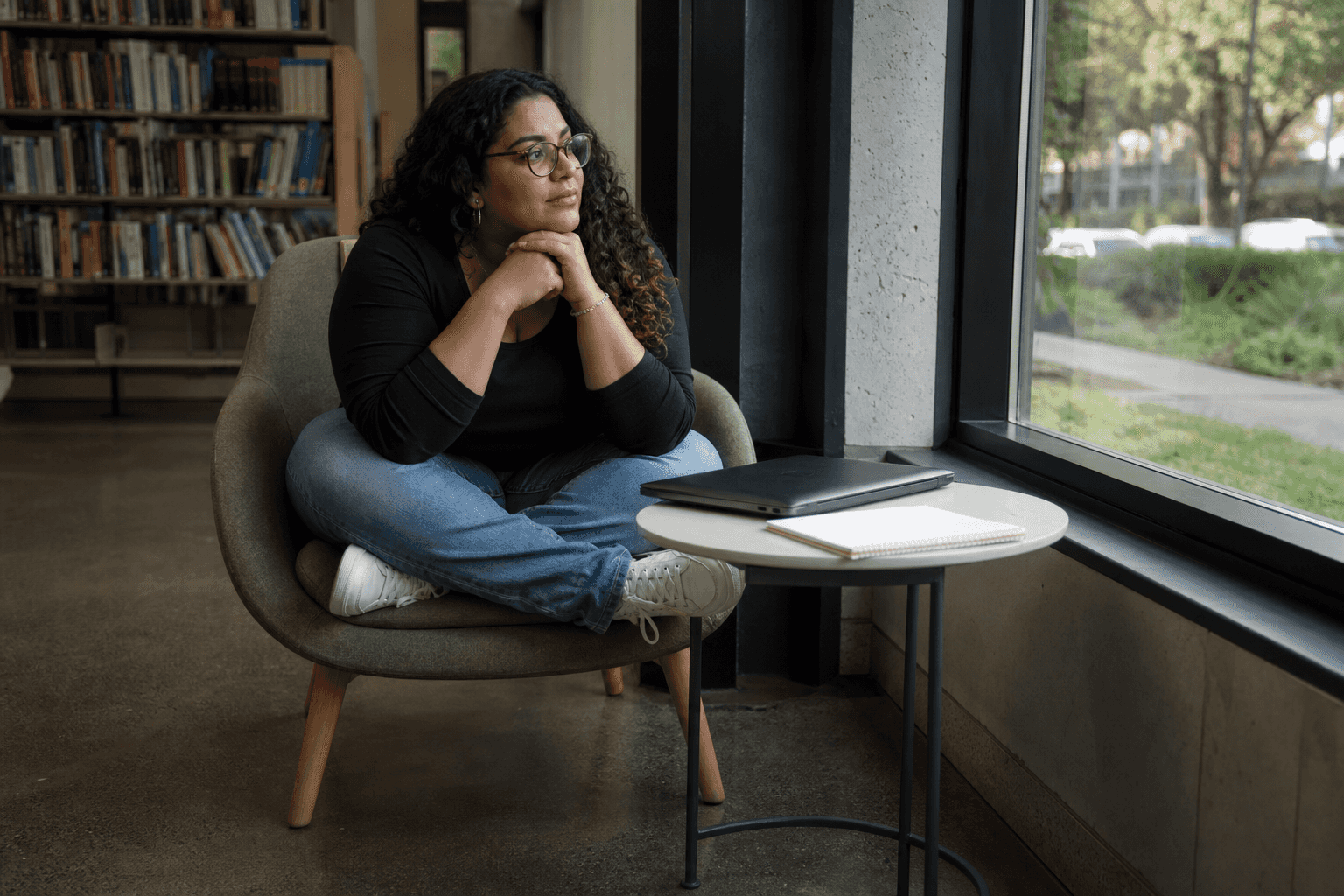 Illustration of a person planning in a library nook with a laptop and notebook. Not a Villa participant, employee, or named person.