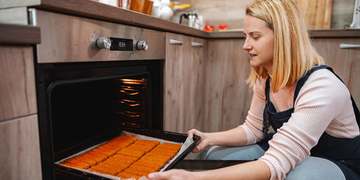Illustration of a person cooking in an accessible kitchen. Not a Villa participant or employee.